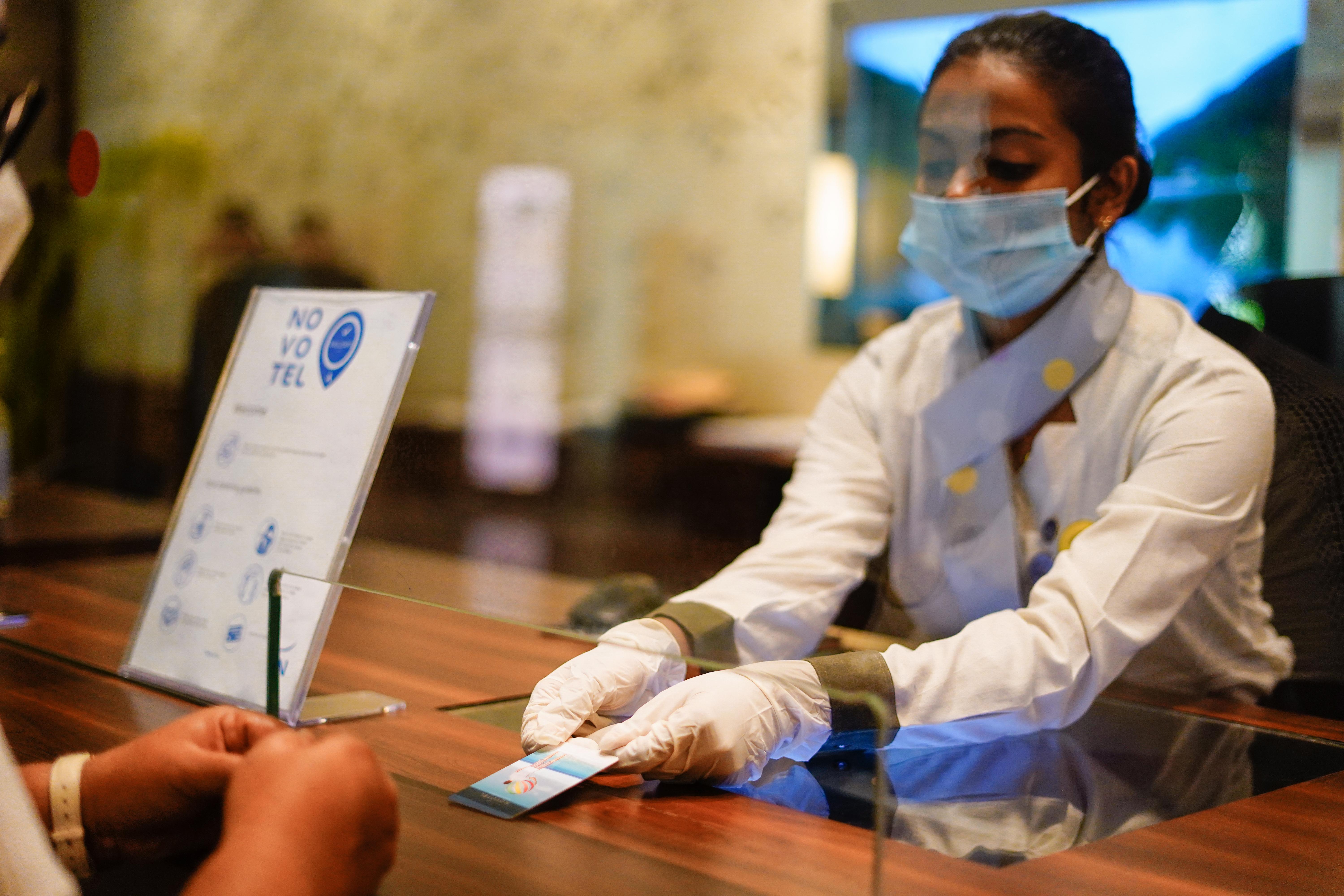 Novotel Goa Resort & Spa Кандолим Екстериор снимка A hotel employee wearing a face mask and gloves